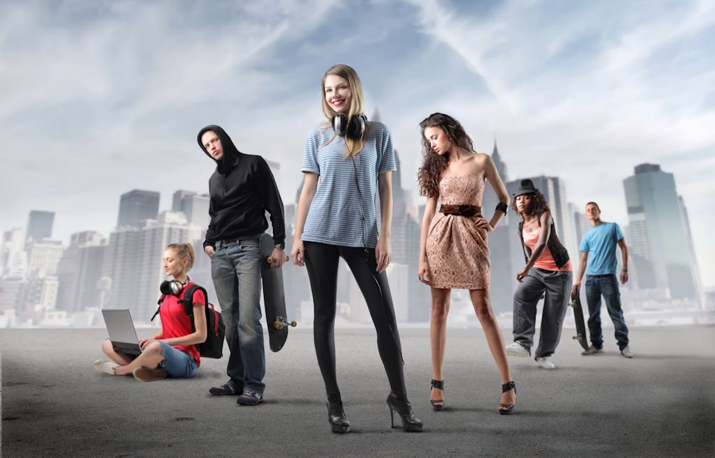 Group Of Young People In Fashion Clothes With Cityscape In The Background